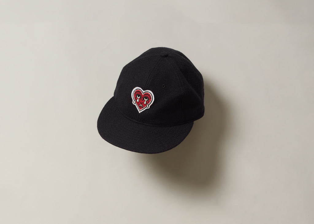 Black cap with a red crying heart logo