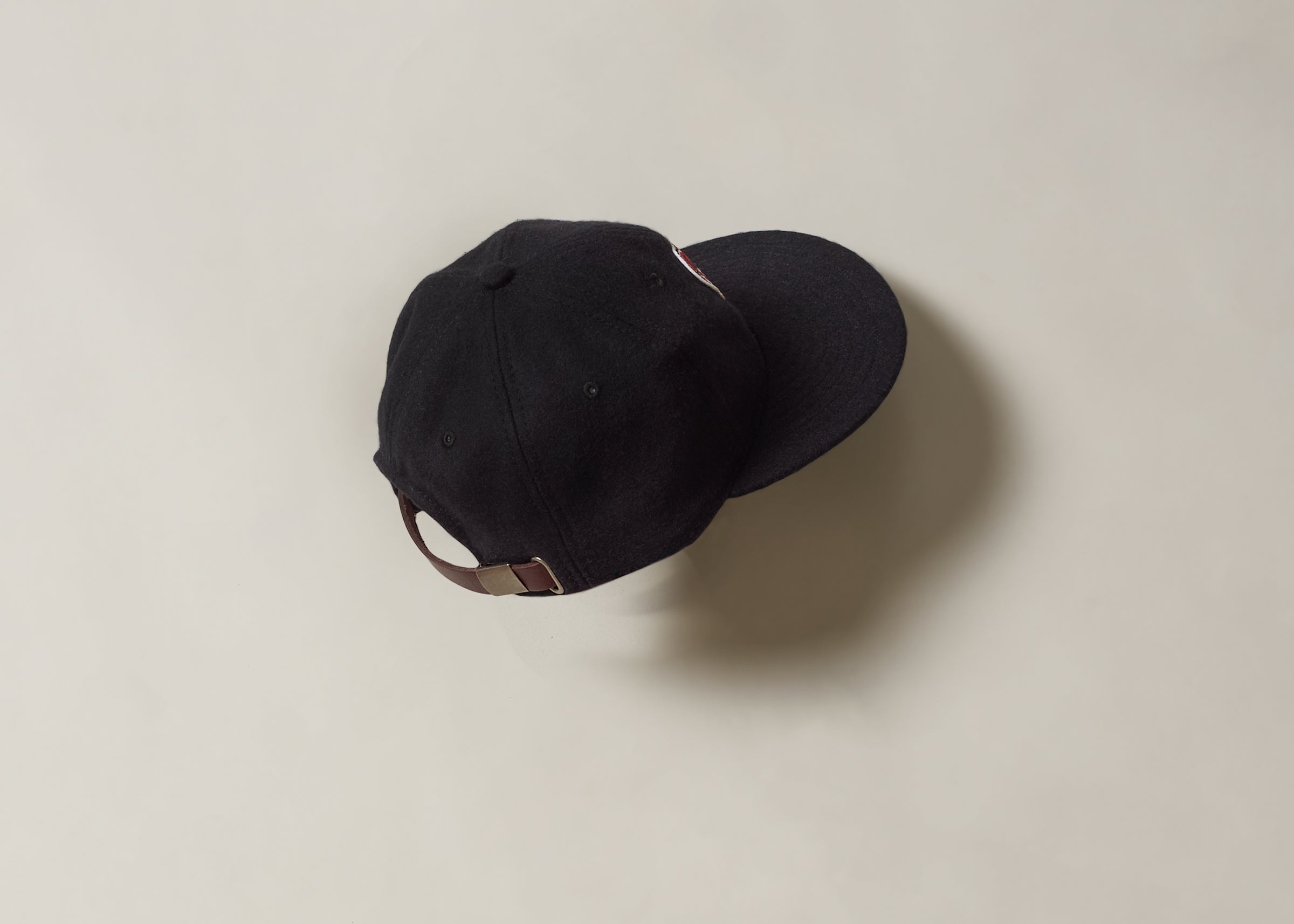 Black cap with a leather strap
